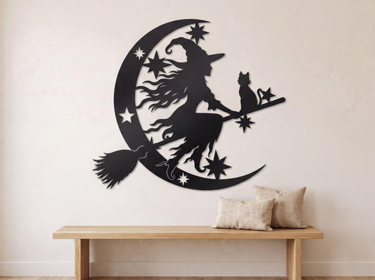 A wall decal depicting a witch riding a broomstick with a cat on a crescent moon, surrounded by stars.