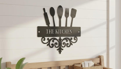 a decorative metal sign that reads "THE KITCHEN" mounted on a wall.