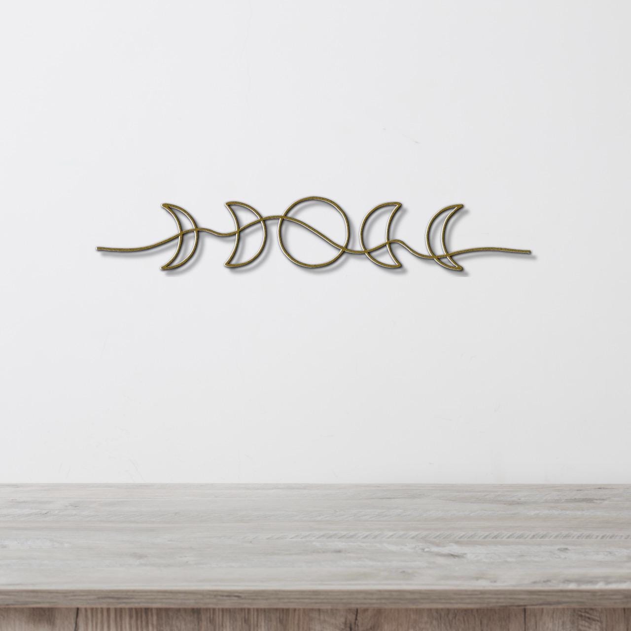 A decorative metal wall hanging depicting the phases of the moon in a linear arrangement.