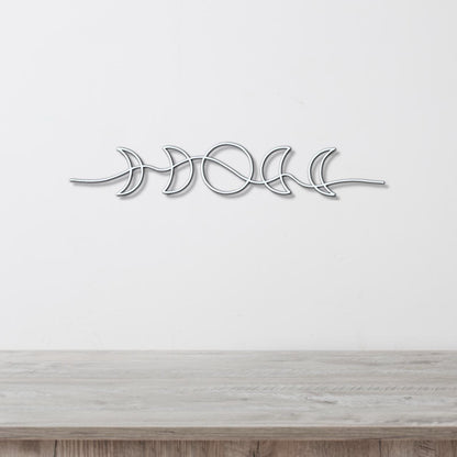 A metal wall art piece depicting the phases of the moon in a minimalist design.