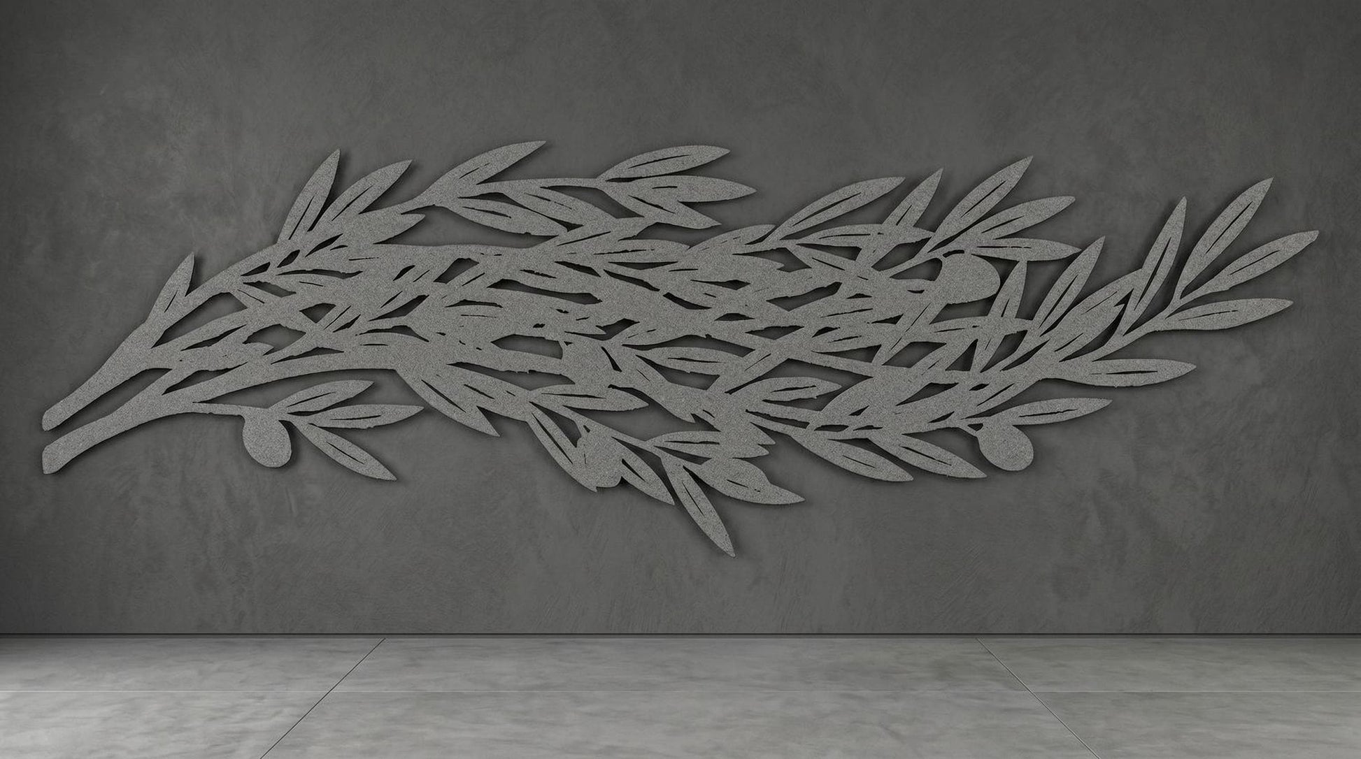 a large, abstract leaf-like design on a grey wall.