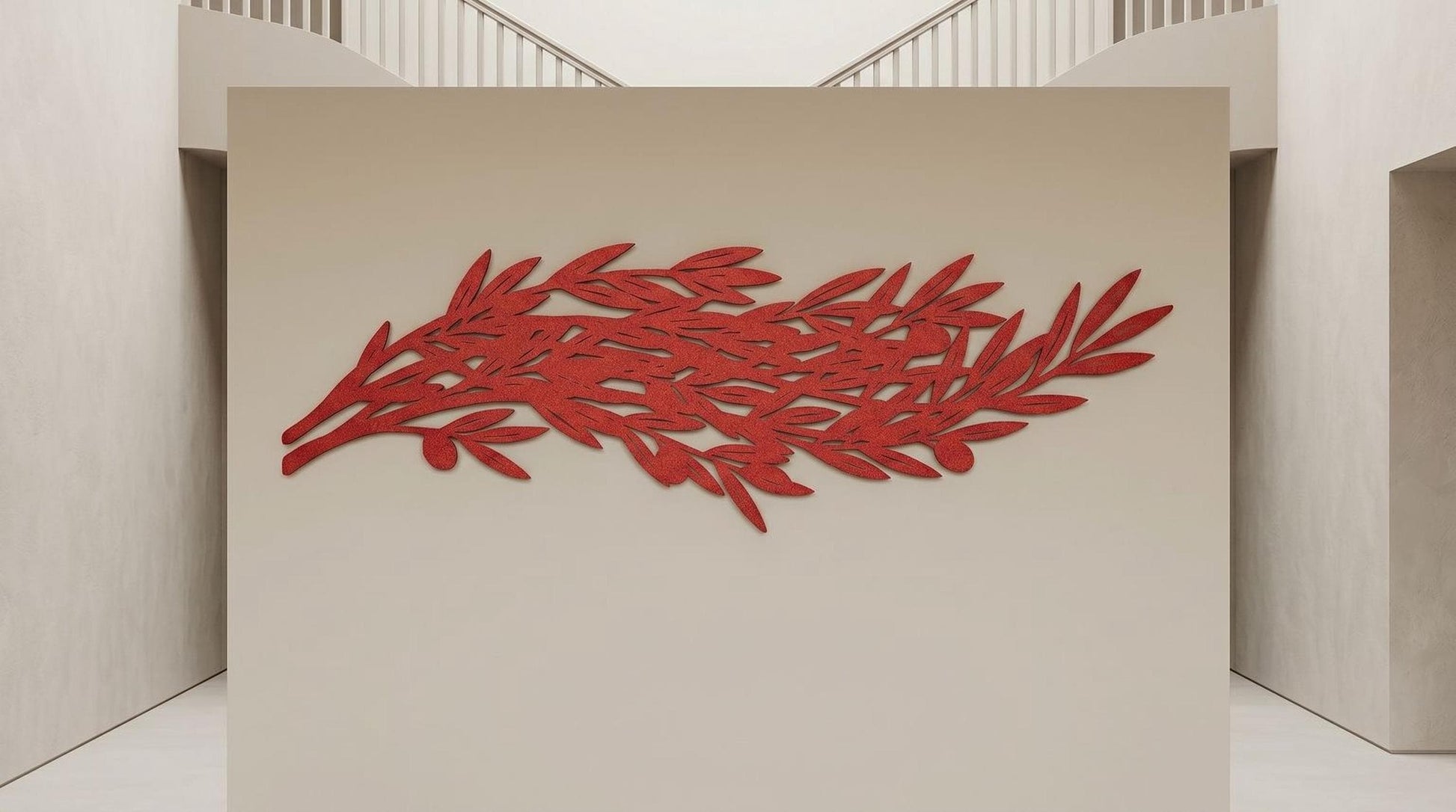 a large, abstract red leaf-like sculpture mounted on a beige wall.