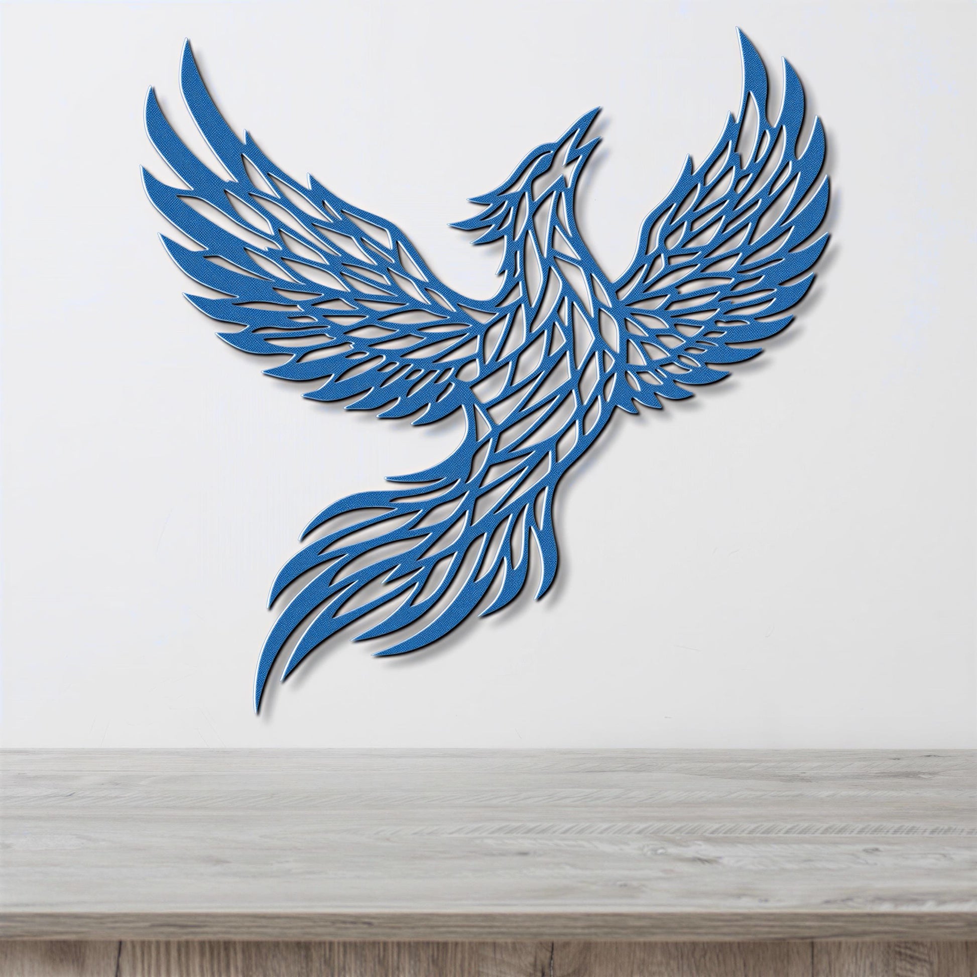 A blue, stylized bird-like figure with outstretched wings is displayed on a white wall above a wooden surface.