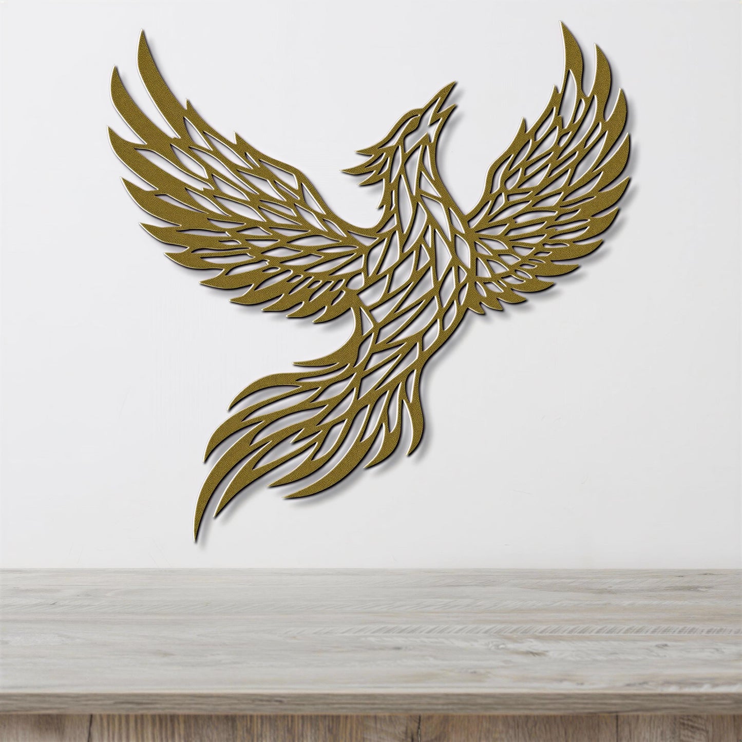 A golden, stylized bird-like figure is displayed on a white wall, with its wings spread wide as if in flight.