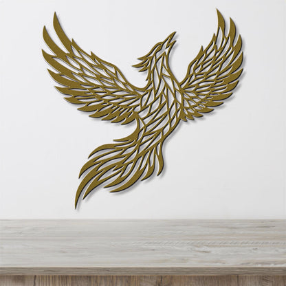 A golden, stylized bird-like figure is displayed on a white wall, with its wings spread wide as if in flight.