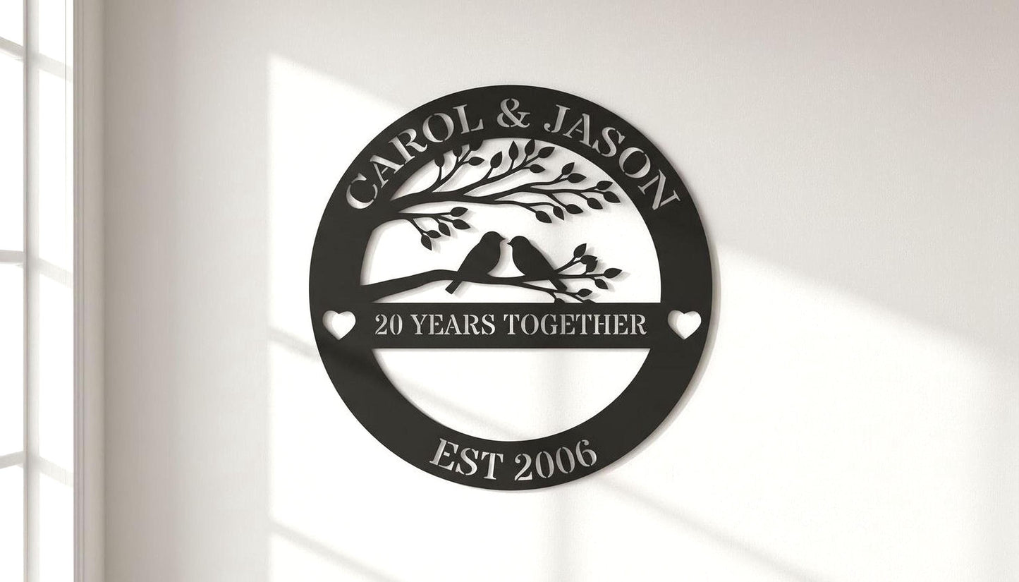 A black and white image of a decorative sign that reads "CAROL & JASON" and "20 YEARS TOGETHER" with a tree and birds on a branch.