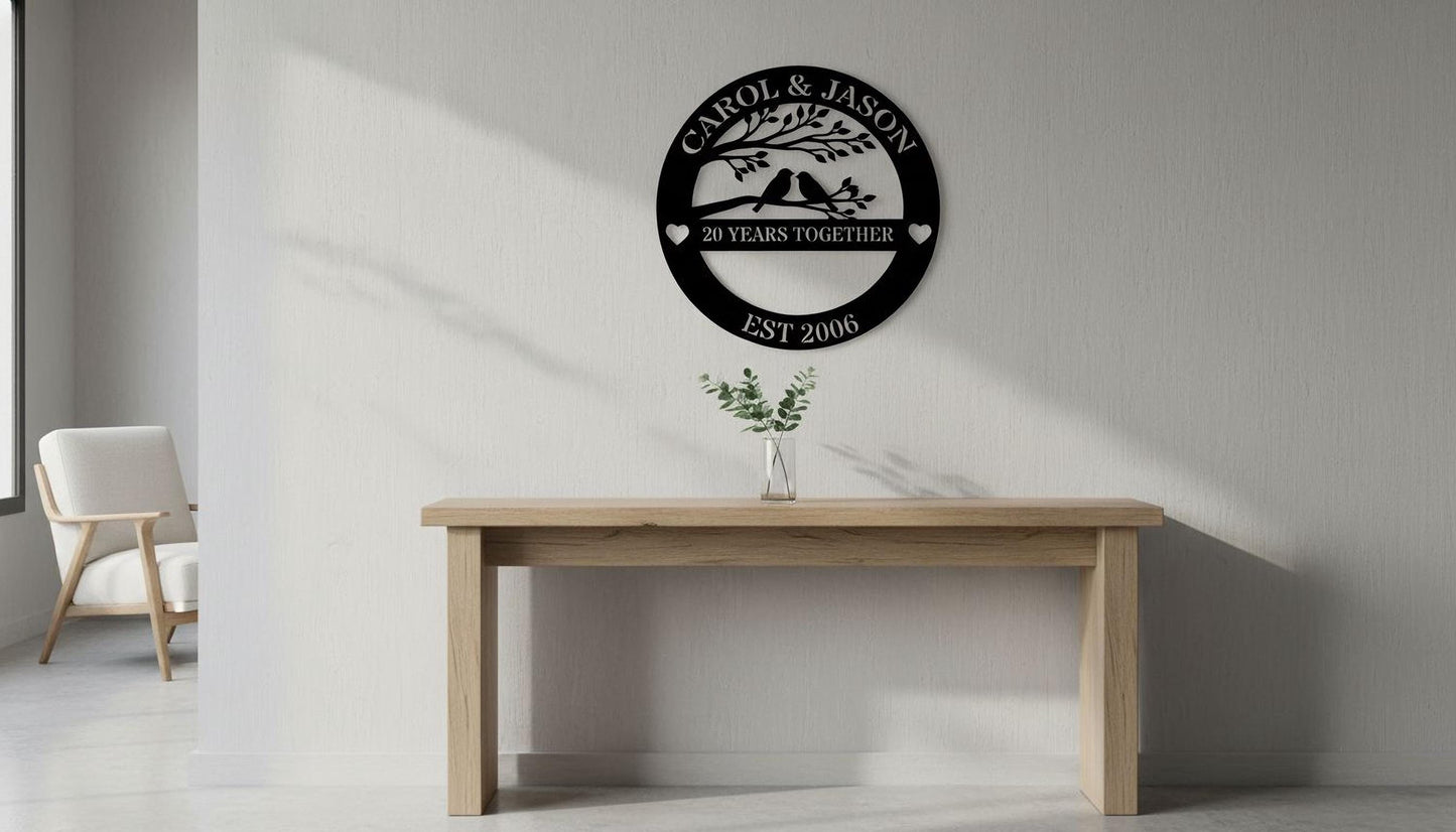 a wooden table with a vase of greenery on it, and a wall-mounted sign that reads "CAROL & JASON 20 YEARS TOGETHER EST 2006" above the table.