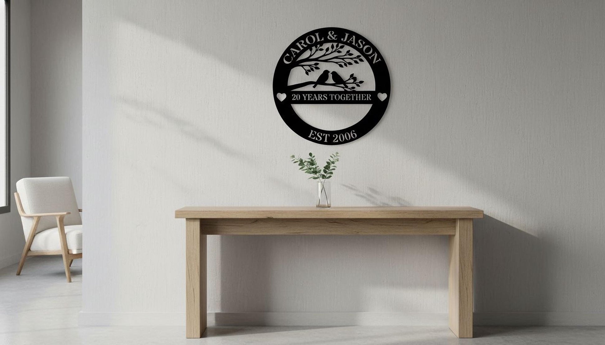 a wooden table with a vase of greenery on it, and a wall-mounted sign that reads "CAROL & JASON 20 YEARS TOGETHER EST 2006" above the table.