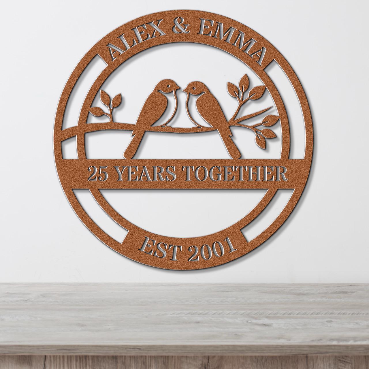 a circular metal sign with the text "Alex & Emma" and "25 YEARS TOGETHER EST 2001" on it.