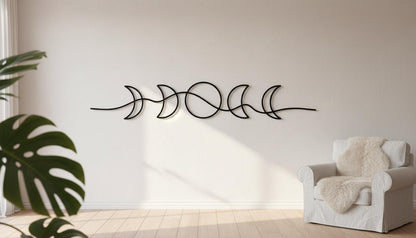 a minimalist living room with a white chair, a potted plant, and a wall art piece depicting a line of crescent moons.