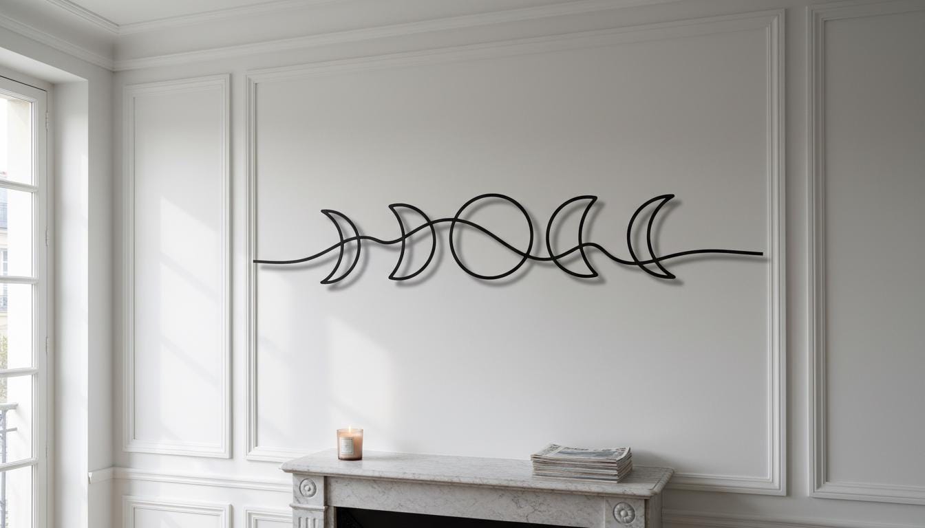 a white fireplace with a decorative metal sculpture of a crescent moon above it. The sculpture is positioned on the wall, creating a visually appealing focal point in the room.