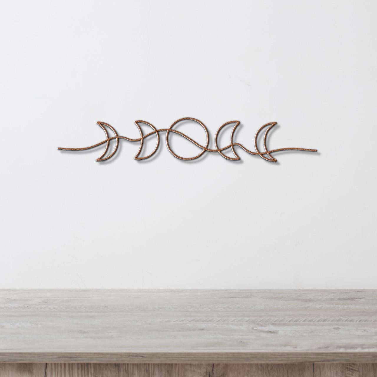 A decorative metal wall hanging depicting the phases of the moon in a linear arrangement.