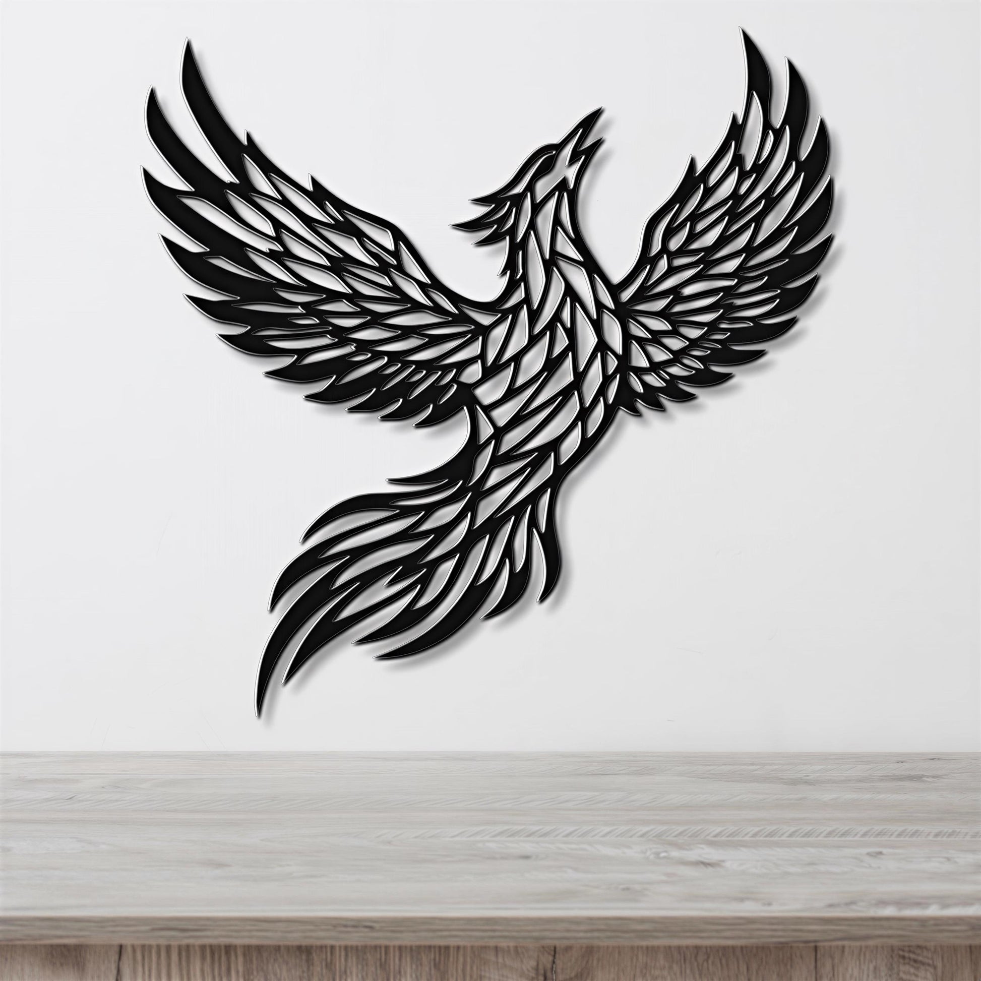 A black and white image of a stylized bird, possibly a phoenix, with outstretched wings and a long tail.