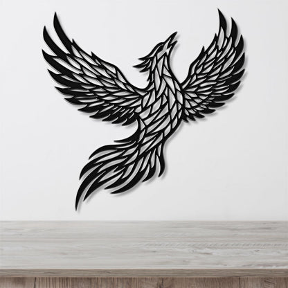 A black and white image of a stylized bird, possibly a phoenix, with outstretched wings and a long tail.