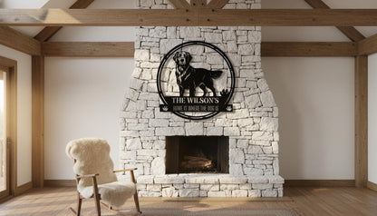a cozy living room with a white stone fireplace and a wooden rocking chair. Above the fireplace, there is a black metal sign with a dog image and the text "The Wilson's Home is where the dog is".