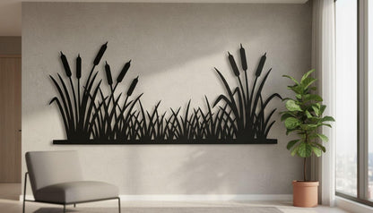 a wall with a large black silhouette of reeds or grasses, creating a striking visual element in the room. A gray chair is positioned in front of the wall, and a potted plant is located to the right of the chair, adding a touch of greenery to the space.