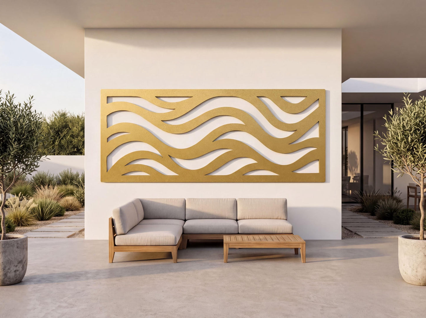 a modern outdoor living space with a white wall, a large gold wavy wall panel, a gray sectional sofa, and a wooden coffee table.
