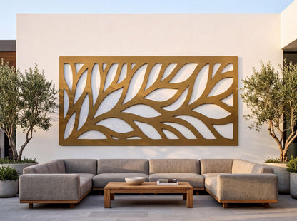 a modern outdoor living space with a large, abstract wall art piece in gold and white colors. The wall art is mounted on a white wall, and it is positioned between two potted plants. In front of the wall art, there is a comfortable seating arrangement consisting of a gray sofa and a wooden coffee table.
