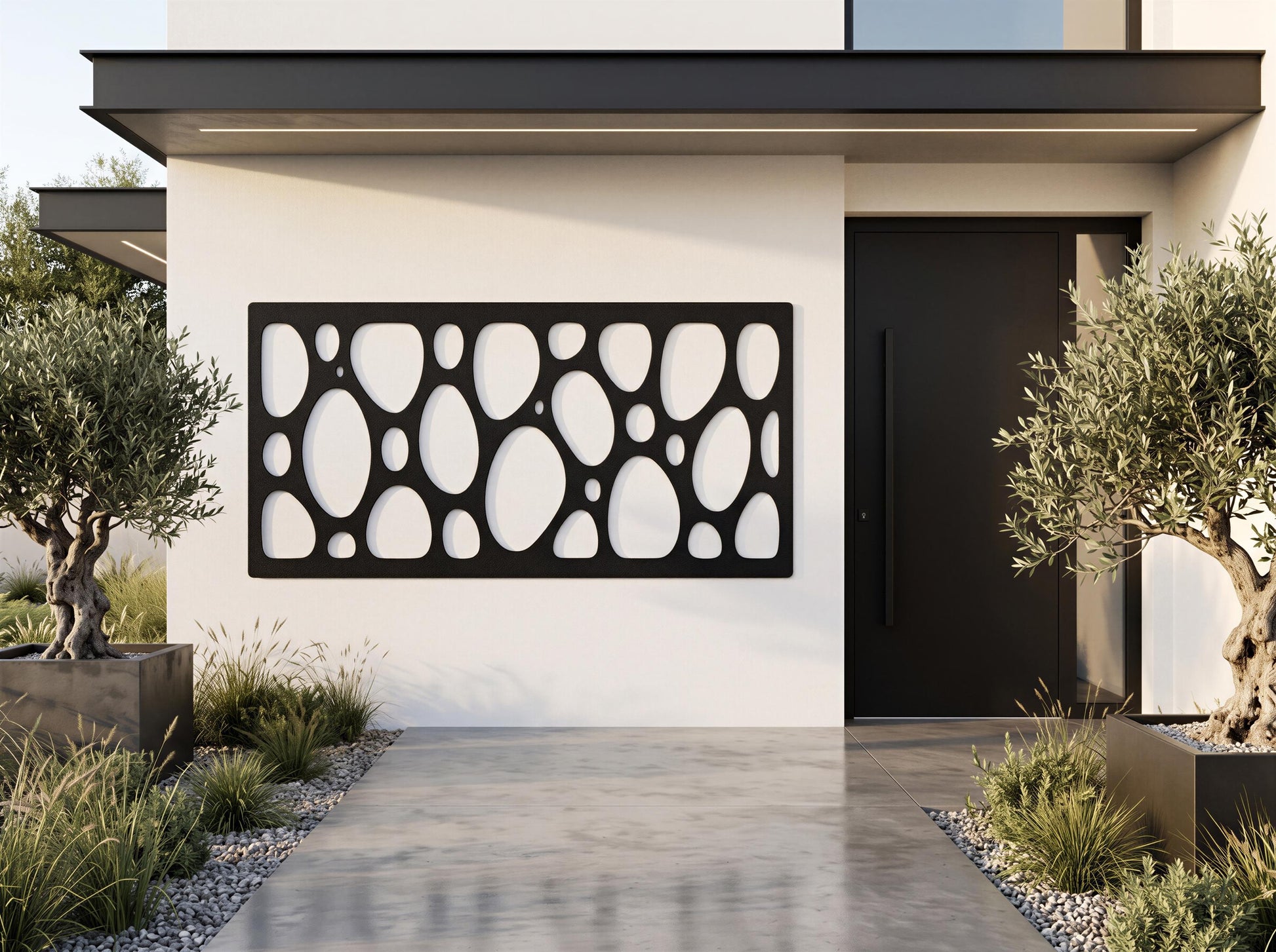 a modern house with a sleek black door and a large black and white geometric pattern on the exterior wall. The house is surrounded by a well-maintained garden with potted plants and a gravel driveway leading up to the entrance.