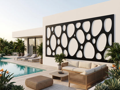 a modern outdoor living space with a pool, lounge chairs, and a large black and white geometric wall design.