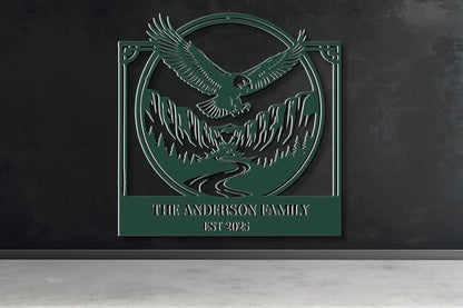 a green metal sign with an eagle and mountains in the background, mounted on a wall.