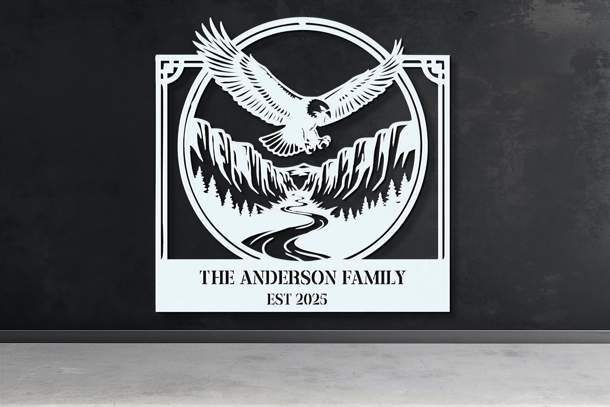 a large white sign with a black eagle and mountains in the background, mounted on a wall.