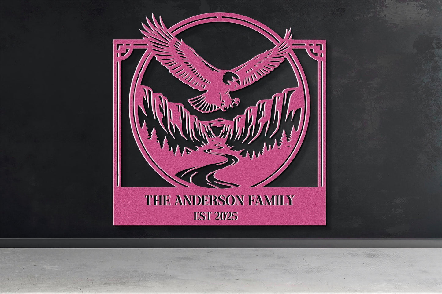 a pink metal sign with a stylized eagle and mountain landscape design.