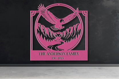 a pink metal sign with a stylized eagle and mountain landscape design.