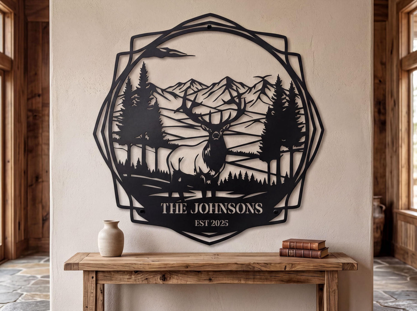 a wall art piece depicting a deer in a forest setting, with mountains in the background. The wall art is titled "THE JOHNSONS" and is displayed on a wall above a wooden table.