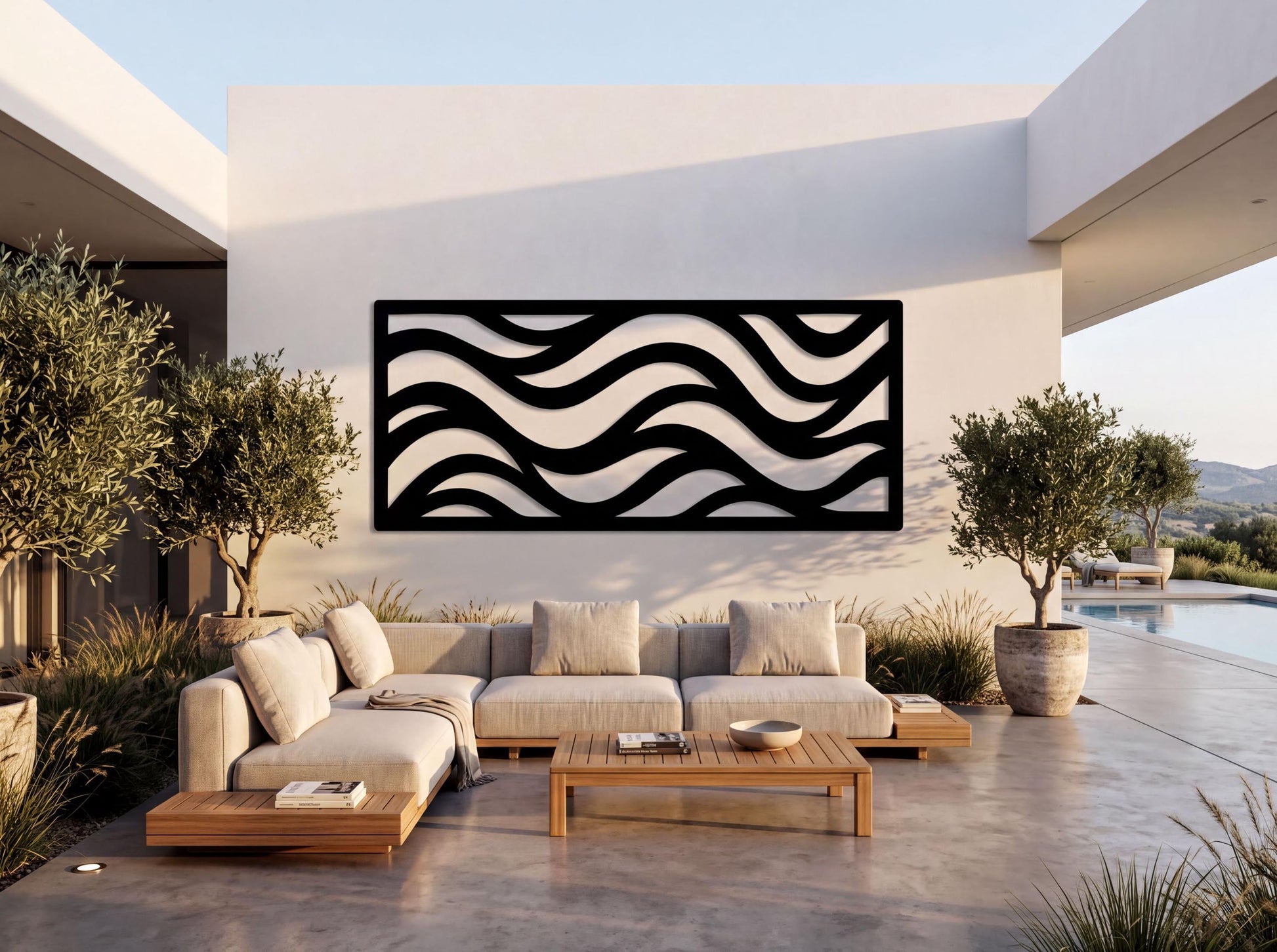 a modern outdoor living space with a large wavy black and white design on the wall behind a comfortable-looking couch and coffee table.