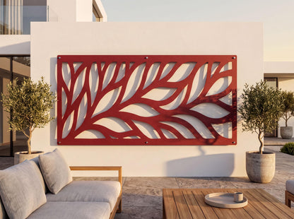 a modern outdoor living space with a large red wall art piece depicting a leaf-like pattern, a wooden table, and two potted plants.