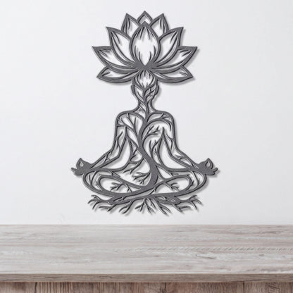 A metal wall art depicting a stylized figure in a meditative pose, with intricate floral and tree-like designs surrounding it.