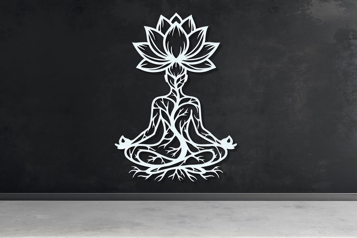 A white silhouette of a person in a meditative pose, with a lotus flower above them, is displayed on a black wall.