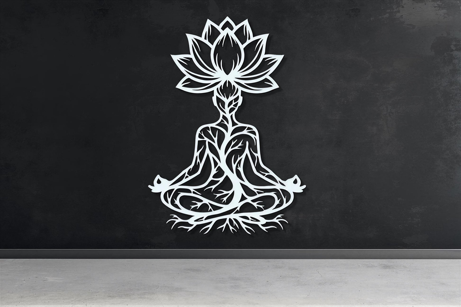A white silhouette of a person in a meditative pose, with a lotus flower above them, is displayed on a black wall.