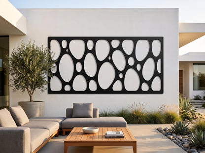 a modern outdoor living space with a large black circular wall art piece, a wooden coffee table, and comfortable seating arrangements.