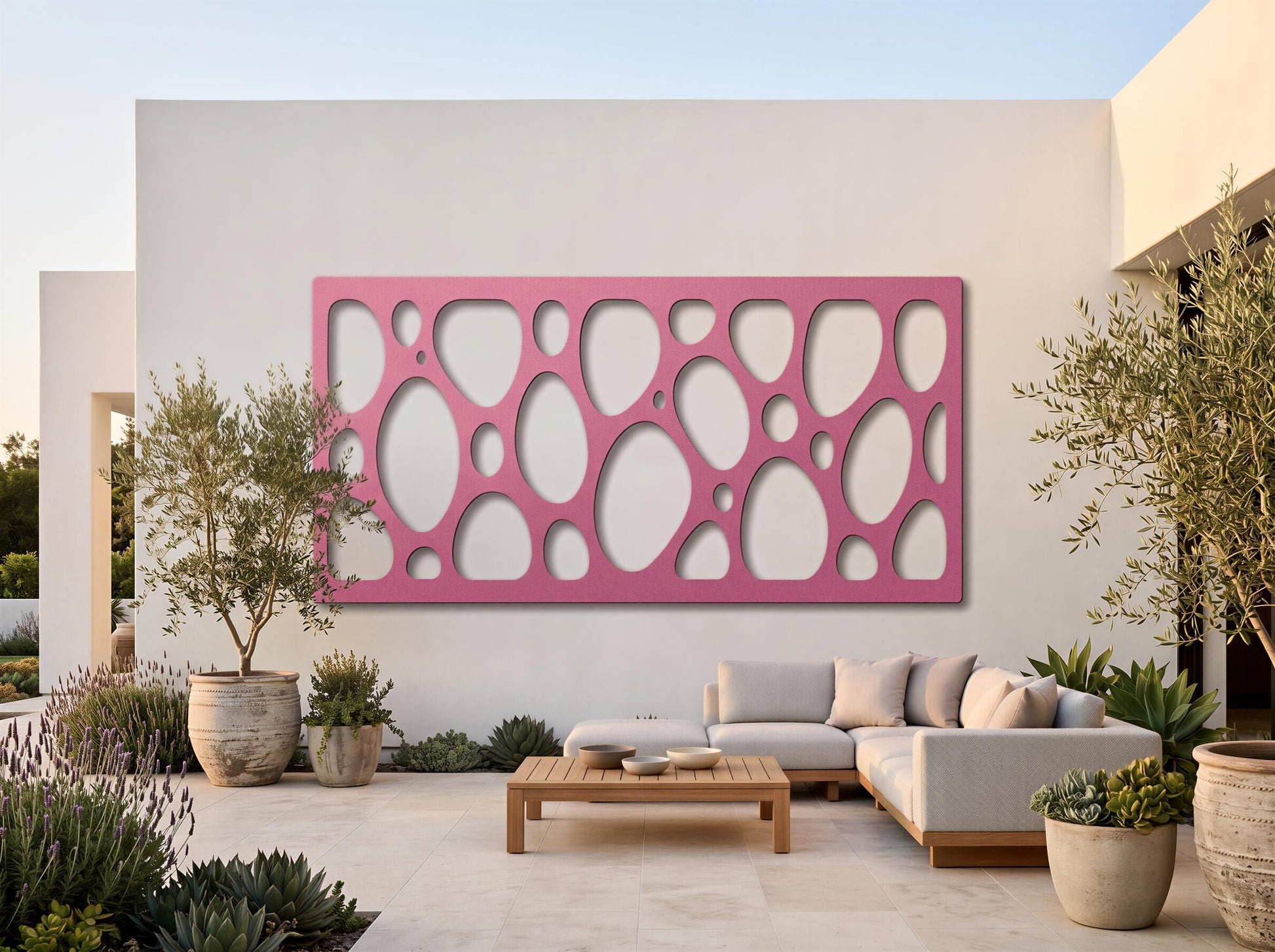 a modern outdoor living space with a large pink wall art piece featuring a repeating pattern of circles. The space includes a comfortable sofa, a wooden coffee table, and several potted plants, creating a cozy and inviting atmosphere.