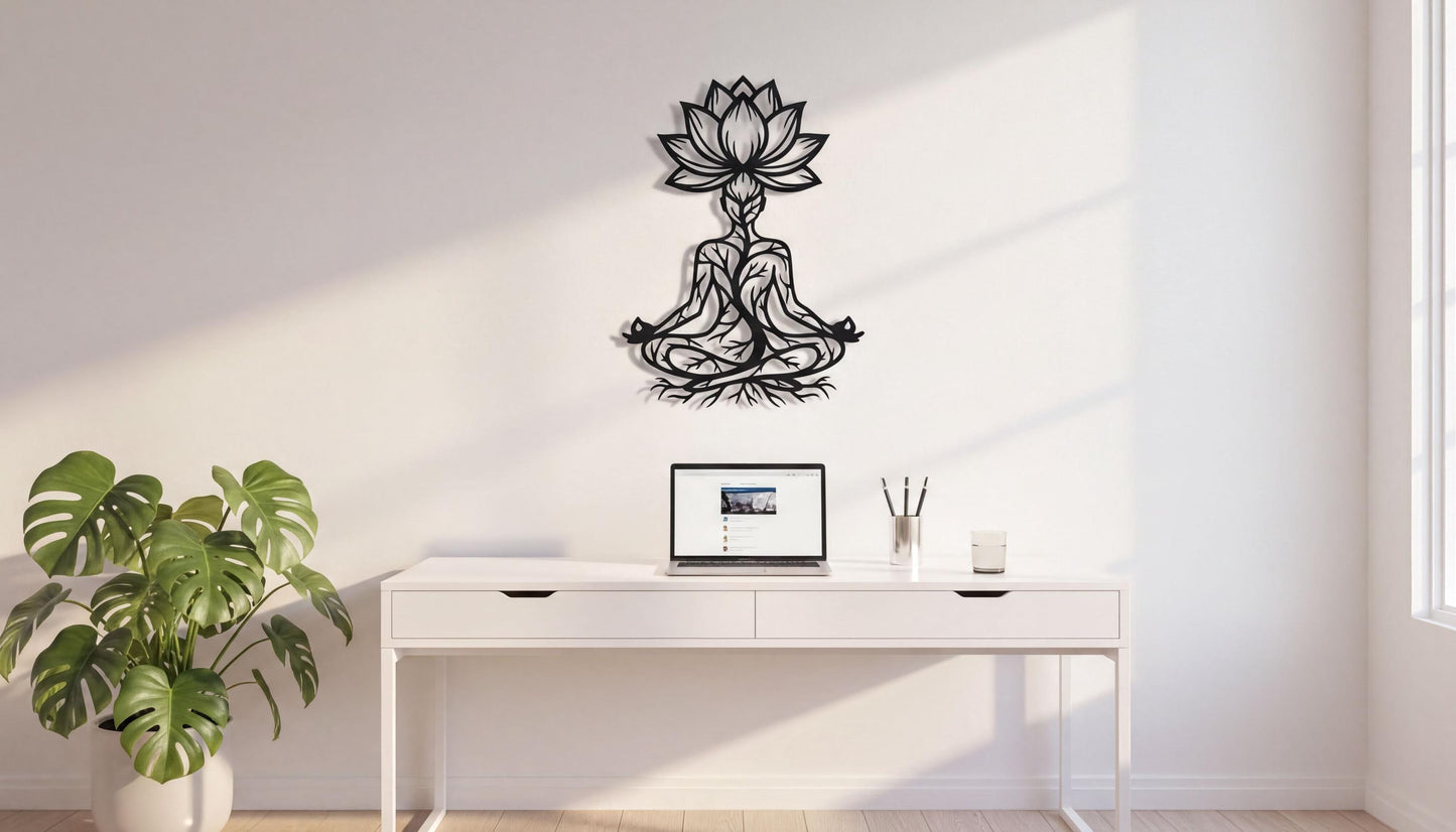 a minimalist workspace with a white desk, a laptop, and a potted plant. A black metal wall art piece depicting a lotus flower is mounted above the desk.