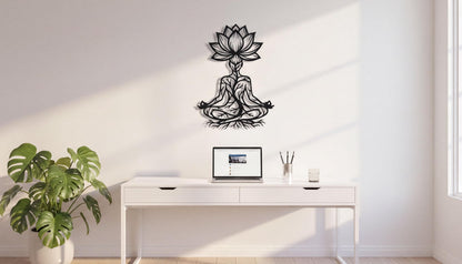 a minimalist workspace with a white desk, a laptop, and a potted plant. A black metal wall art piece depicting a lotus flower is mounted above the desk.