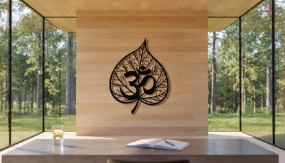 a modern interior design with a large wooden wall adorned with a leaf-shaped metal art piece displaying the Om symbol, which is a significant symbol in Hinduism and yoga. In front of the wall, there is a wooden desk with a glass table, and a glass of water is placed on the desk.